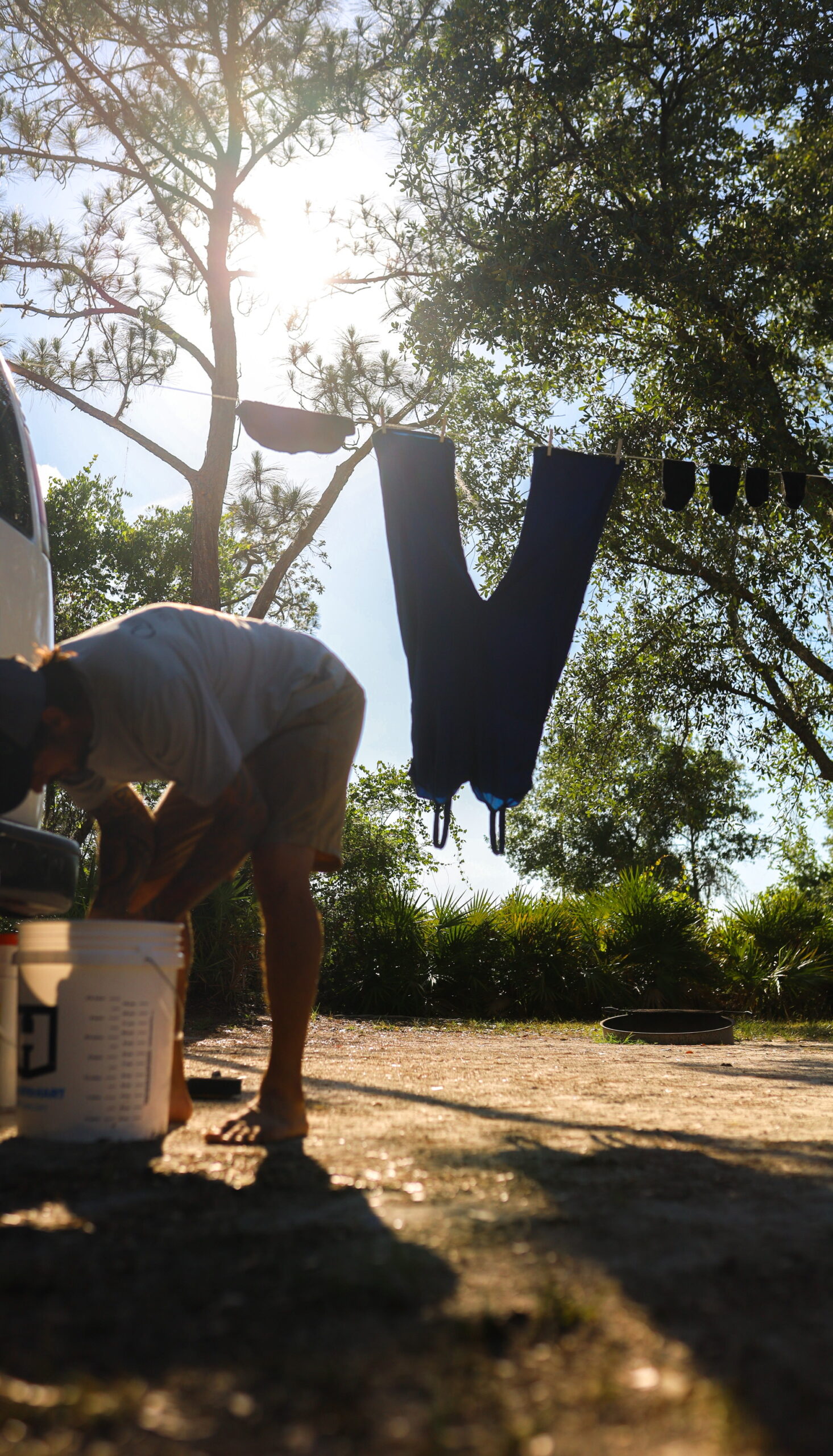 Cleaning clothes and hanging on clothes line to dry at campground